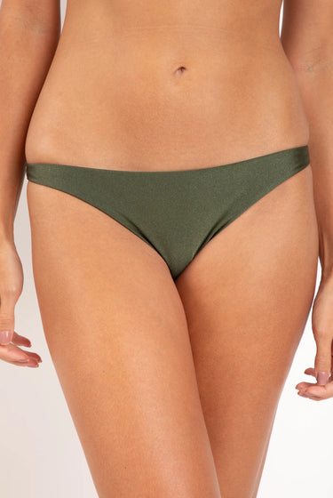 Person wearing a green bikini bottom on a plain background