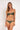 Woman wearing a green bikini set on a white background