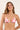 Woman wearing a red and white floral bikini against a beige background