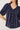 Navy blue striped blouse with white buttons on a plain background
