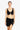 Woman wearing a black bikini top and black sarong on a white background