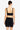 Woman wearing a black bikini top and sarong on a white background