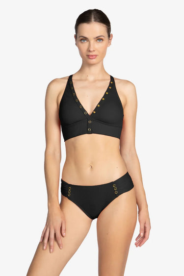 Woman wearing a black bikini with gold accents on a white background