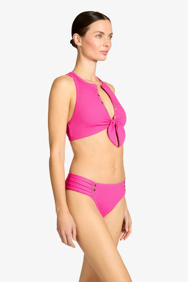 Woman wearing a pink bikini set on a white background
