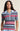 Woman wearing a colorful striped polo shirt against a beige background