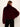 A woman shown from the back wearing a cropped, plush faux-fur jacket in deep burgundy with black pants, set against a plain off-white background.