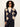 A model with curly black hair and sunglasses wearing a navy blue cardigan with a beige argyle pattern, styled with a cream top and dark jeans against a plain light background.