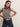 Model wearing a navy and ivory striped sleeveless knit sweater with navy pinstripe wide-leg pants.