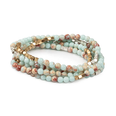 Multistrand beaded bracelet with turquoise and gold beads on a white background