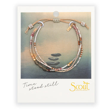 Beaded necklace on a Scout branded card with a scenic background