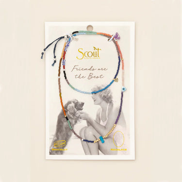 Scout bracelet packaging with two bracelets on a beige background