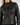 a woman wearing a black leather jacket with a vintage feel and zipper detailing with blue jeans on a white background