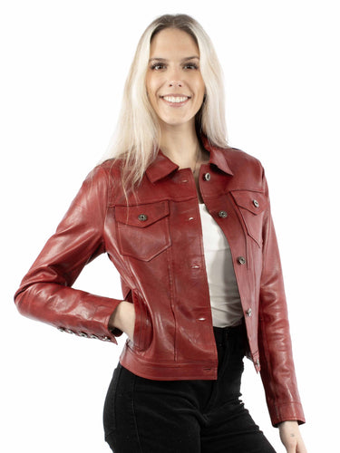 A woman wearing a soft red leather jacket and black pants on a white background