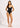 Woman wearing a black swimsuit with white trim on a plain background