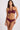 A front view of a wrap halter burgundy swim top on a model on a white background
