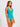 Woman wearing a teal swimsuit against a white background