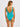 Woman wearing a teal swimsuit on a plain background