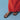 Brown sandals worn with a red skirt on a blue background