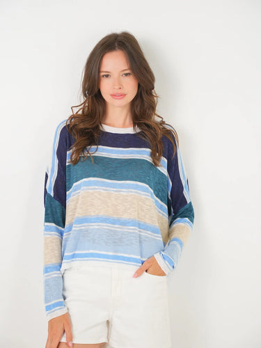 Woman wearing a striped sweater against a plain background
