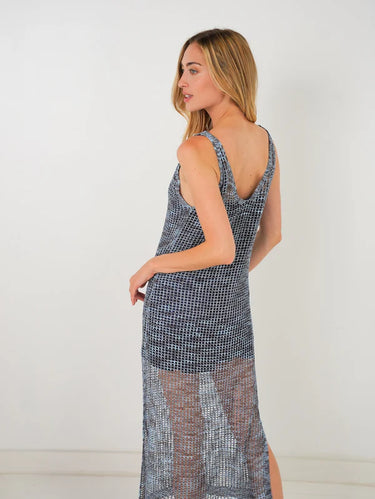 Woman wearing a patterned dress with a white background