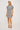 Woman wearing a patterned dress on a white background