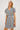 Woman wearing a black and white patterned dress on a white background