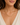 a woman wearing a gold chain necklace