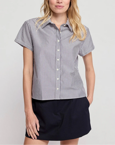A woman wearing black striped boxed collared shirt and a black mini skirt