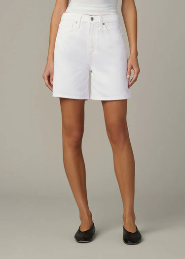 A women wearing white High Rise Shorts on a neutral background