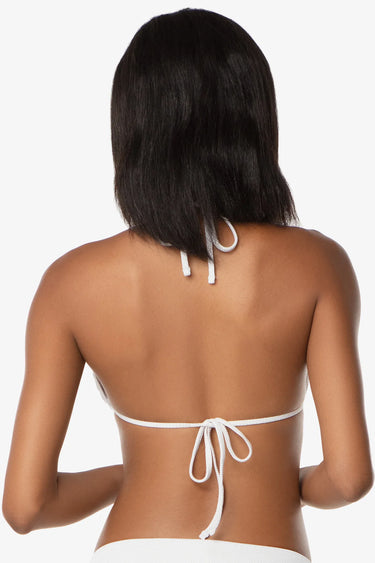 Woman wearing a white bikini top with thin straps on a white background