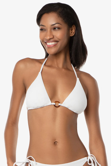 Woman wearing a white bikini against a plain background