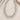 A beaded necklace made of translucent pale blue-green round beads separated by tiny multicolored spacer beads, arranged on a light beige textured surface.