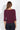 Plum off-the-shoulder three-quarter sleeve top with a relaxed draped fit, styled with dark wash jeans on a model.