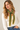 a woman wearing a cashmere dark green knit with yellow-green stitching
