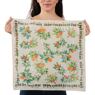 Person holding a bandana with floral and fruit pattern