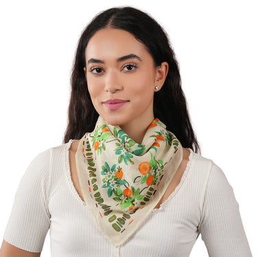 Woman wearing a floral patterned scarf on a white background