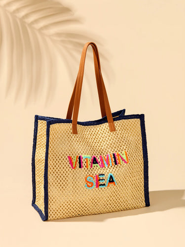 Woven tote bag with 'Vitamin Sea' text on a beige background