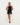 Woman wearing a black halter neck dress on a white background