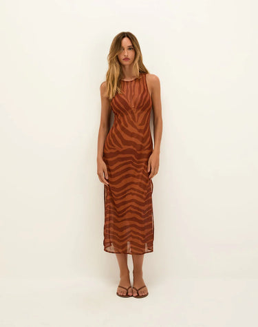 Woman wearing a brown zebra-striped dress against a white background