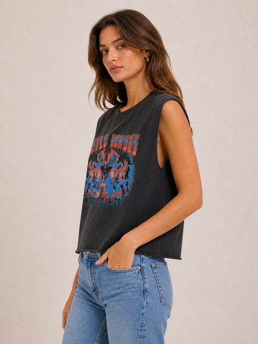 A woman wearing a sleeveless black tank with a 80s style band logo on the front