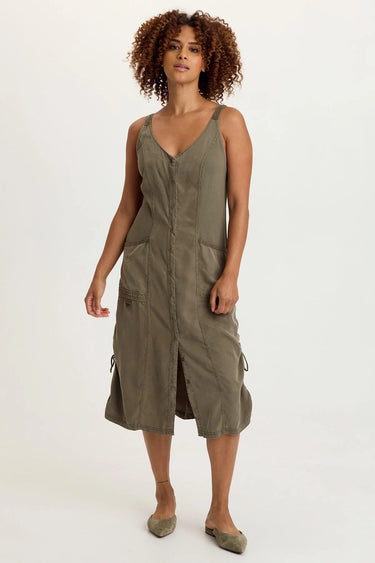 A woman wearing a moss green snap up dress