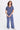 A woman wearing a blue twill v-neck short sleeve top and matching cargo pants on a white background.