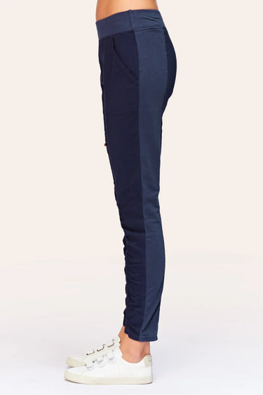 Navy blue pants worn by a person on a white background