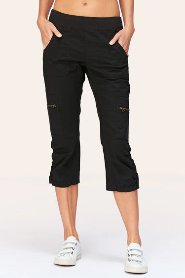 Black capri pants worn by a person on a white background
