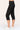 Black capri pants worn by a person on a white background