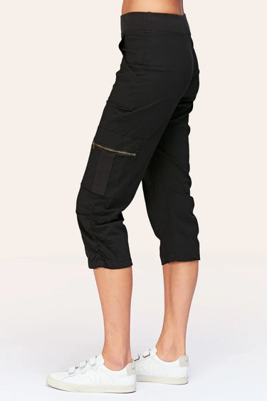 Black capri pants worn by a person on a white background