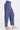 A side view of the blue twill cargo pants with a zippered pocket on each thigh, with an elastic waistband and two side pockets.