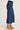A woman wearing wide-leg cropped gaucho pants in navy on a white background
