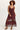 Woman wearing a burgundy crochet dress on a white background