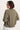 a woman wearing a moss green cargo jacket